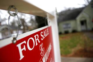 A "For Sale" sign hangs in front of an existing home in Atlanta. 