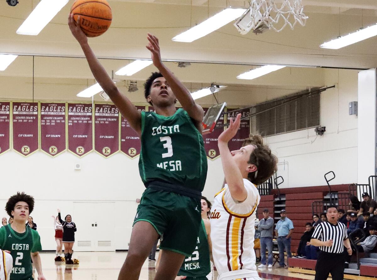 Costa Mesa's Marlee Slone (3) makes a layup against Estancia on Friday night.