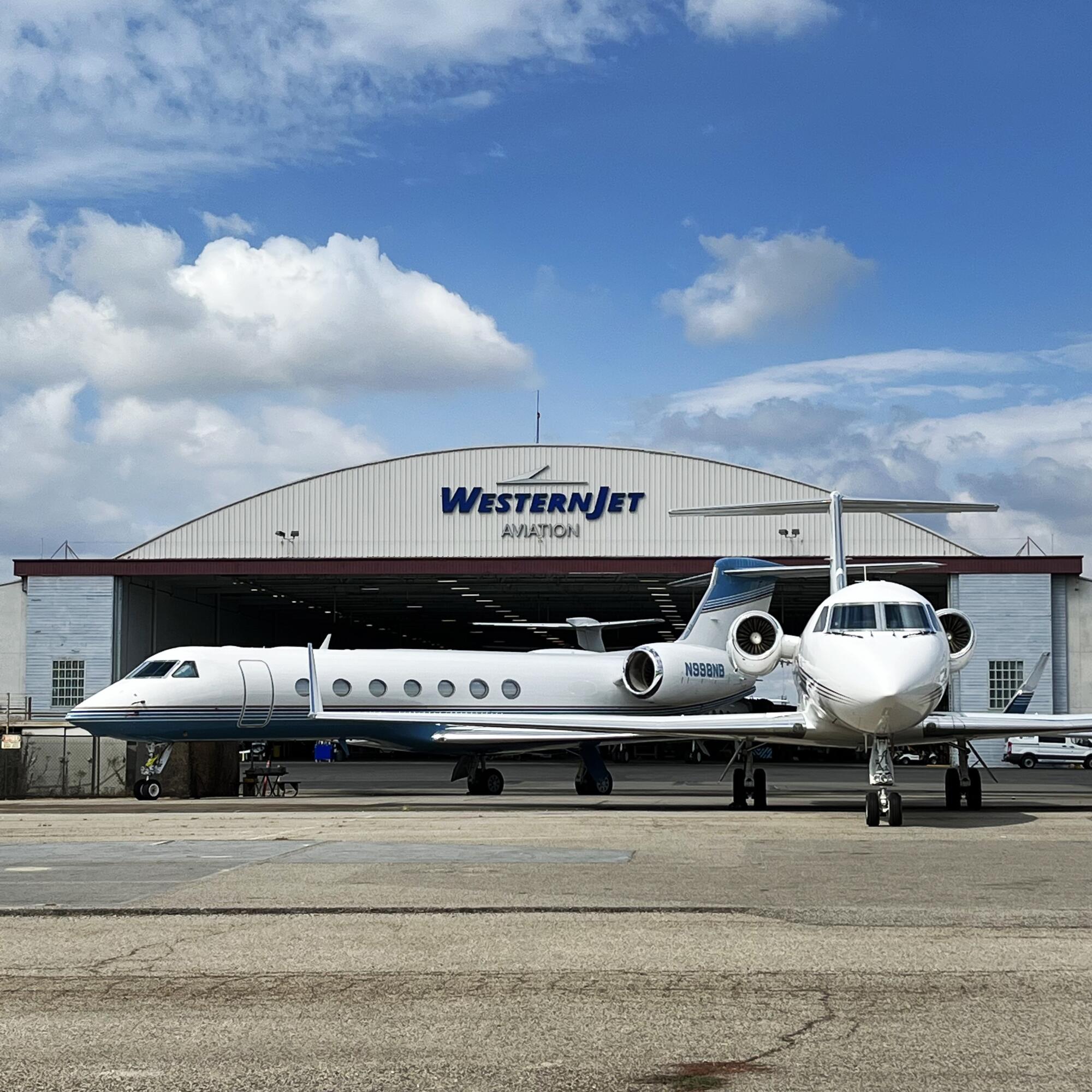 Two private jets are seen in front of the Western Jet hangar at Van Nuys Airport.