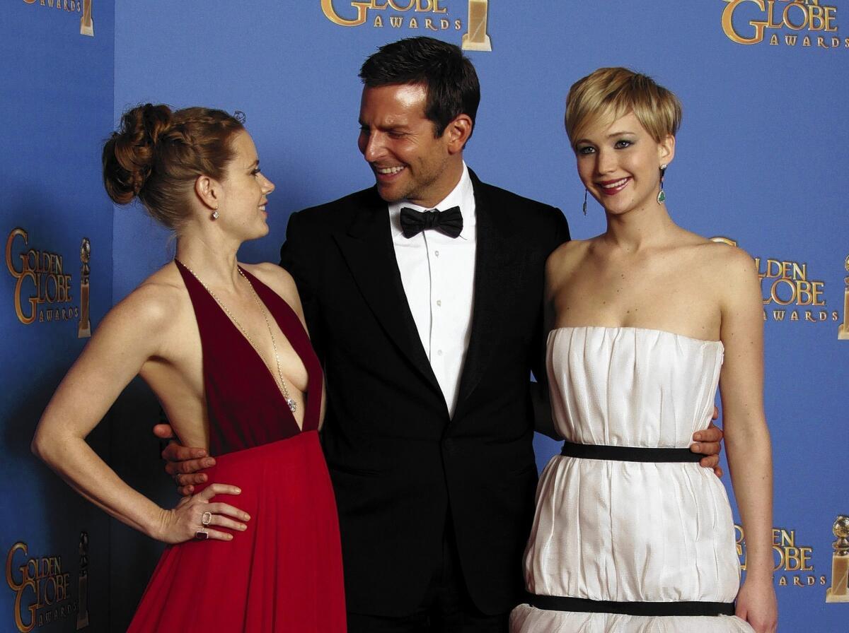 Amy Adams, left, Bradley Cooper, and Jennifer Lawrence after "American Hustle" won the Golden Globe for motion picture, comedy or musical.