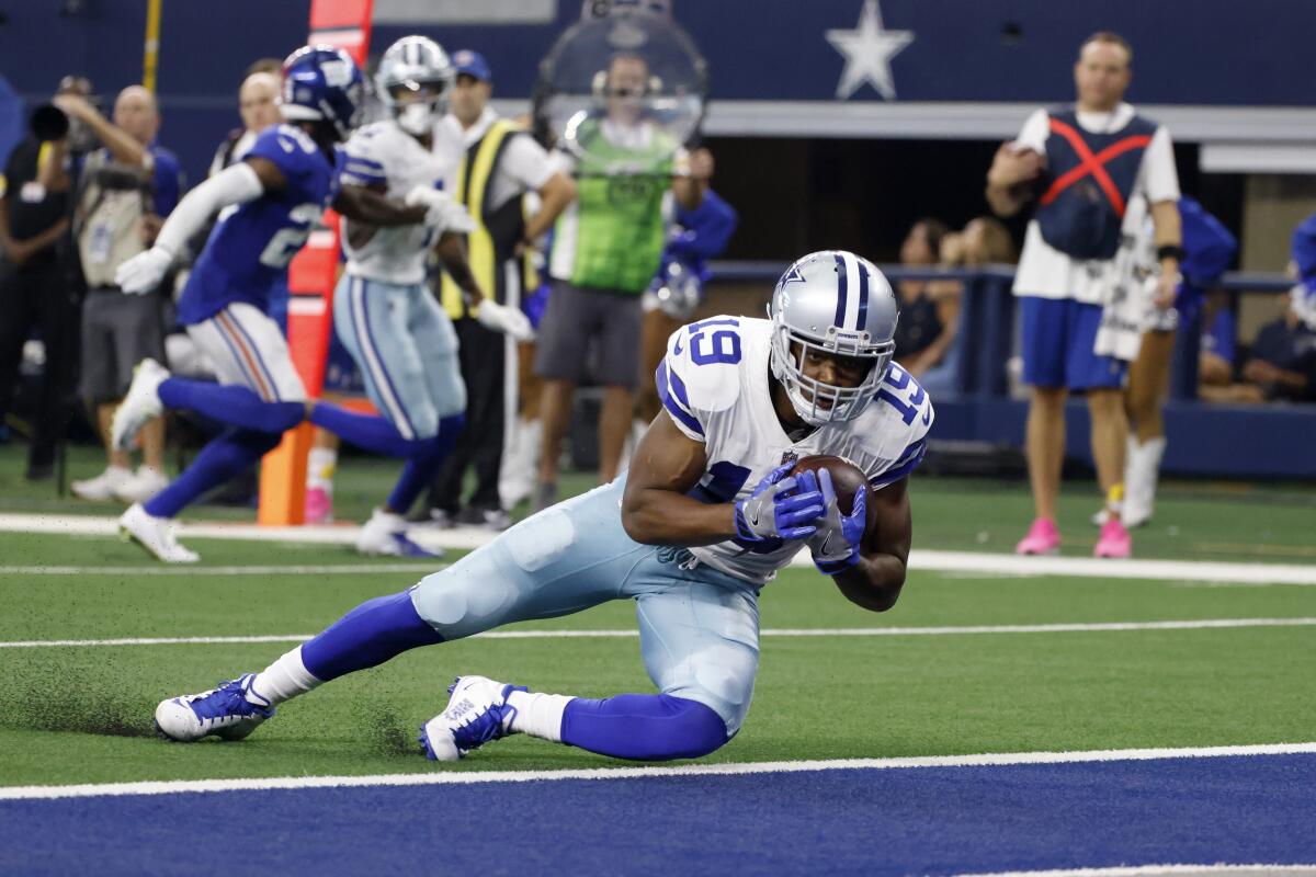 Dallas Cowboys wide receiver Amari Cooper catches a touchdown pass in the first half of an NFL football game against the New York Giants in Arlington, Texas, Sunday, Oct. 10, 2021. (AP Photo/Ron Jenkins)
