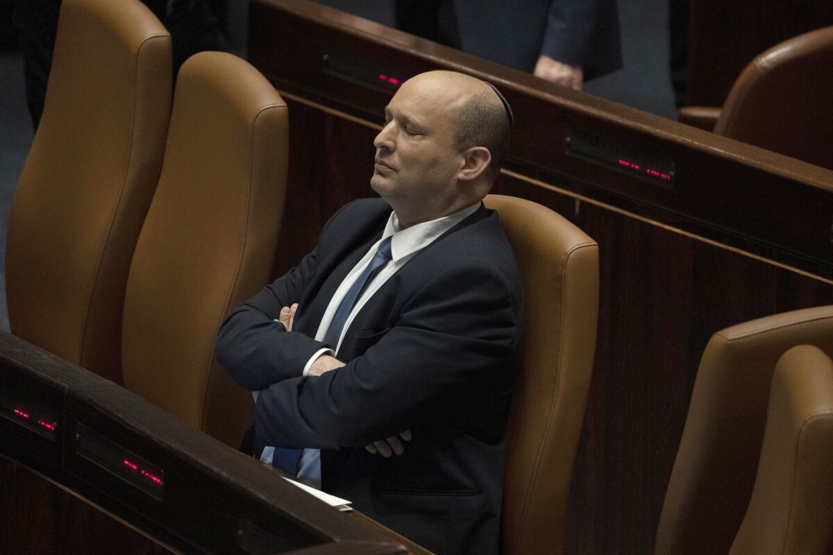 Israeli Prime Minister Naftali Bennett pauses during the opening of the summer session of the Knesset, Israel's parliament, in Jerusalem, Monday, May 9, 2022. Less than a year after taking office, Bennett has lost his parliamentary majority, his own party is crumbling and a key governing partner has suspended cooperation with the coalition. That has set the stage for a possible attempt by the opposition, led by former Prime Minister Benjamin Netanyahu, to topple the government later this week. (AP Photo/Maya Alleruzzo)