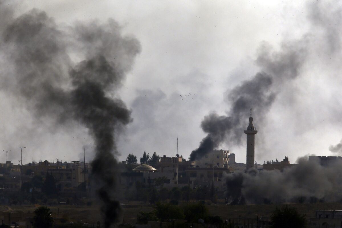 Smoke billows from targets in Syria during bombardment by Turkish forces
