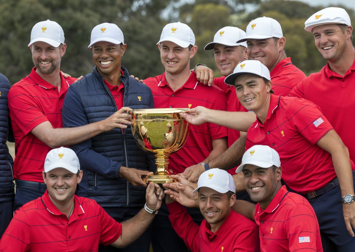 U.S. team captain Tiger Woods and his teammates pose with the Presidents Cup after their win over the International team on Dec. 15.