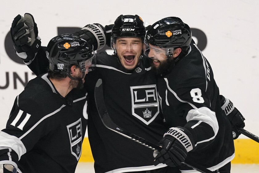 Kings forward Dustin Brown celebrates with Anze Kopitar and Drew Doughty after scoring against the Minnesota Wild.
