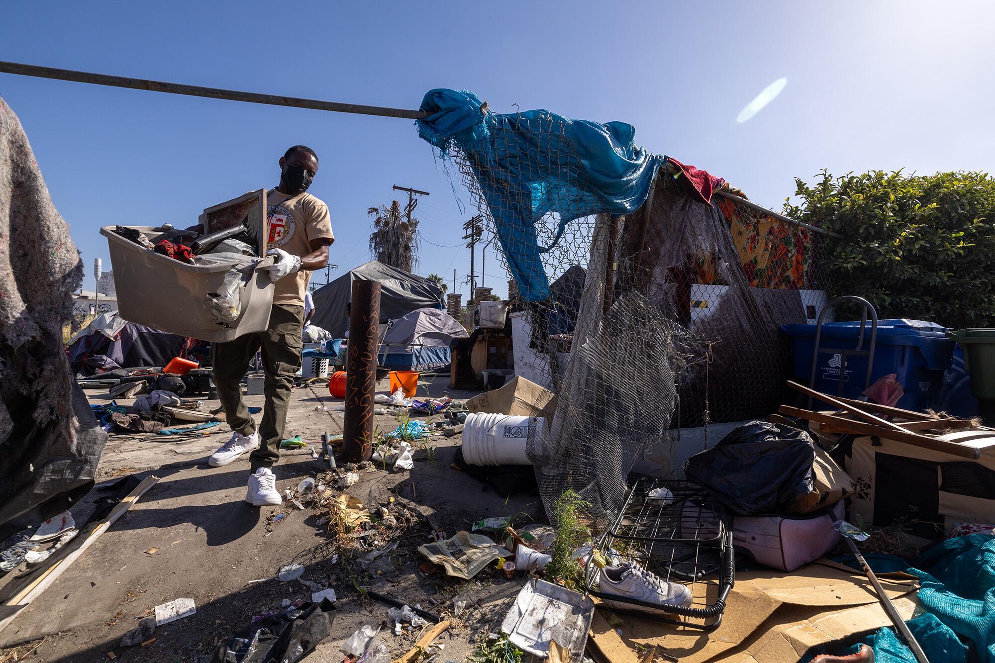 Inside Safe workers clean up a homeless encampment in South Los Angeles