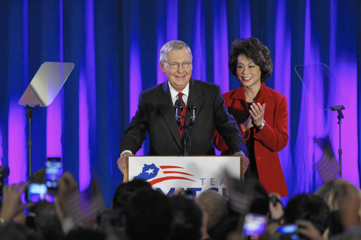 Senate Minority Leader Mitch McConnell, joined by his wife, Elaine Chao, celebrates in Louisville, Ky.
