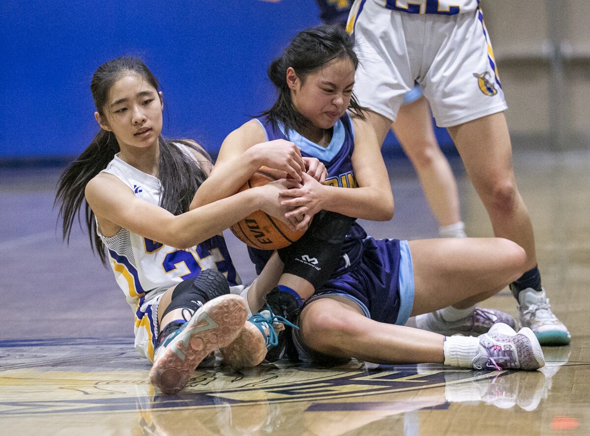 Marina's Kim Nguyen battles for a lose ball against Gahr's Christine Ho during Saturday's playoff semifinal game.