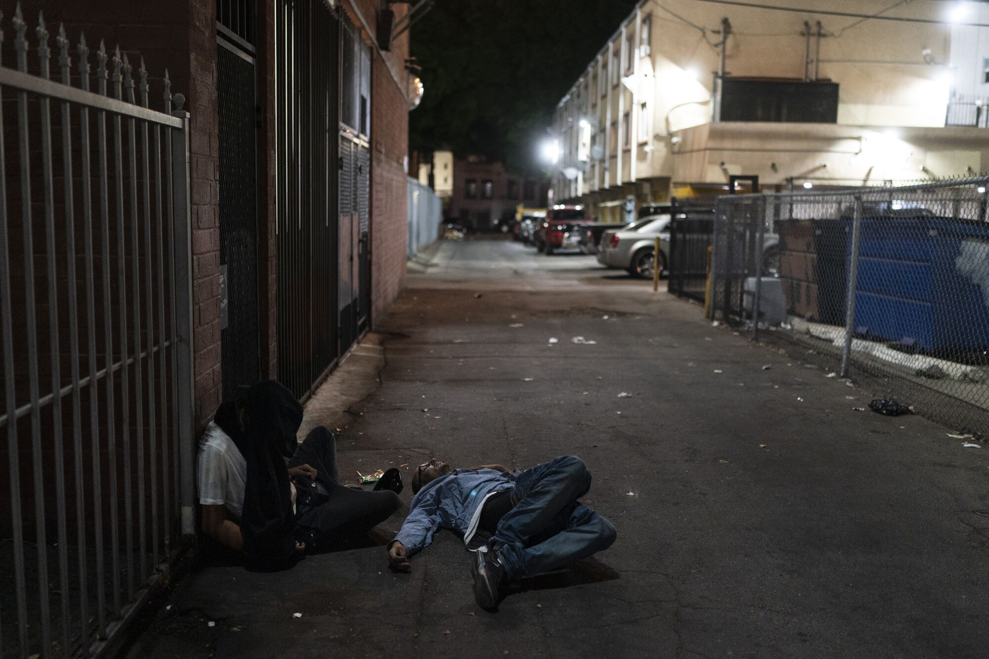 Two drug users sleep in an alley in Los Angeles.