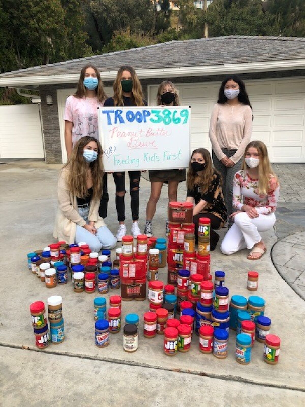 La Jolla-based Girl Scout Troop 3869 collected 130 jars of peanut butter during a food drive.