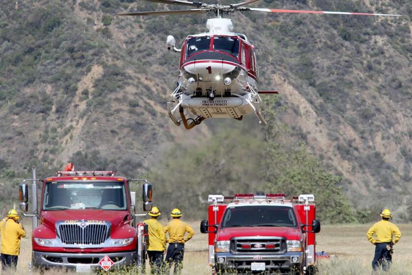 An OCFA helicopter lands after dropping search and rescue members into areas that have not been already searched in Cleveland National Forest on Tuesday, April 2.