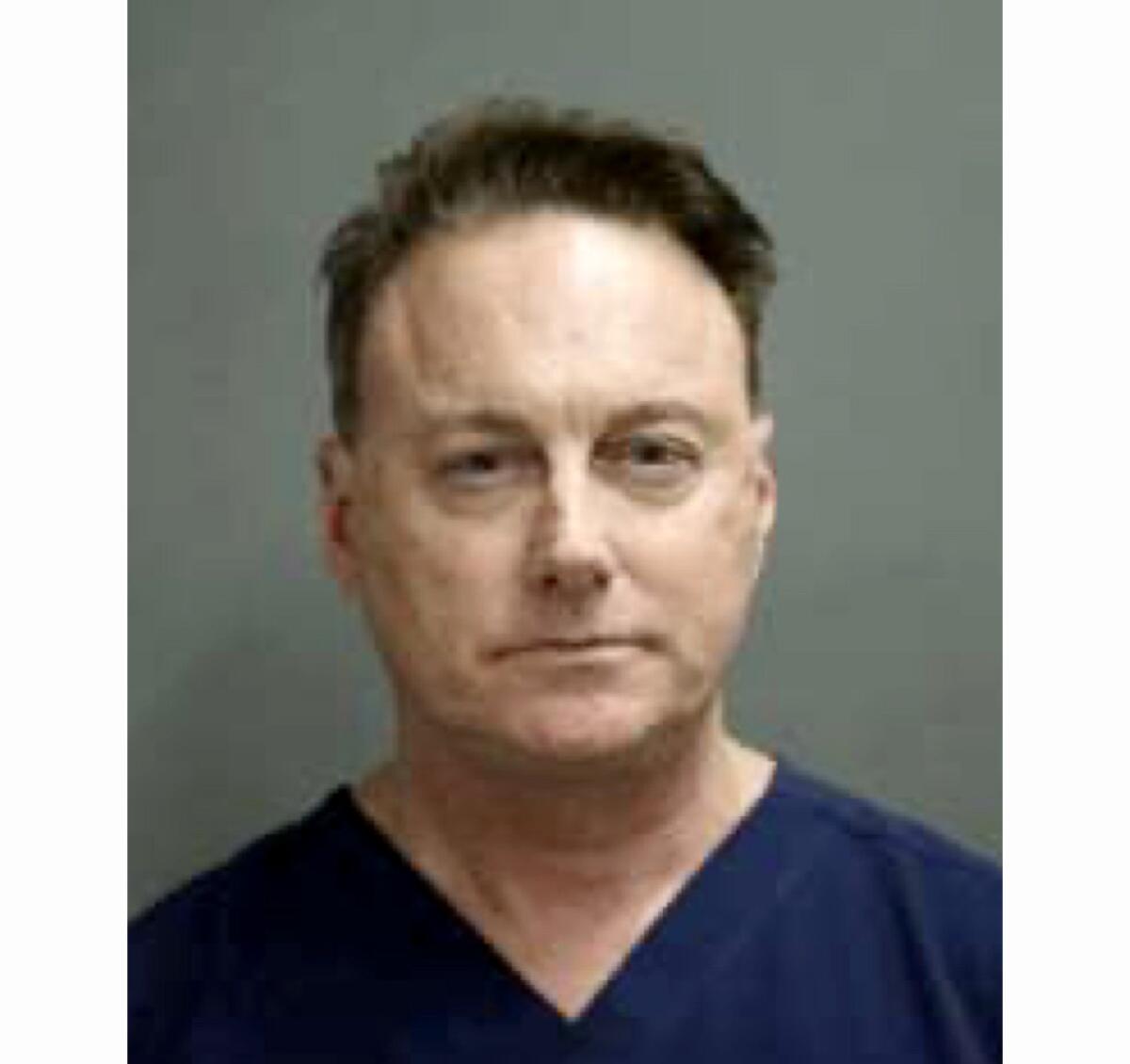 A police booking mugshot of Dr. William Thompson IV
