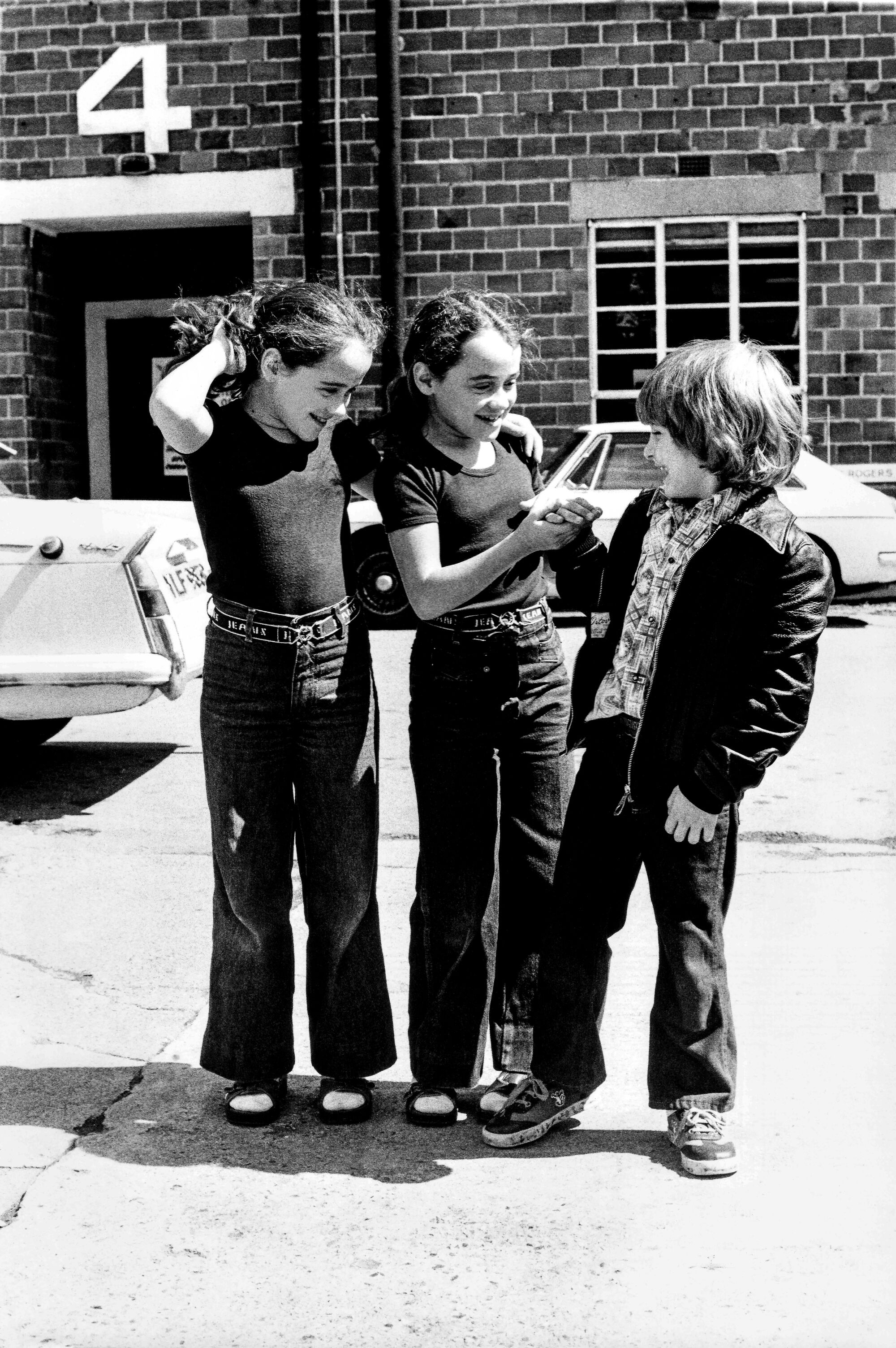 Lisa and Louise Burns, who played the fictional Grady twins, play with Danny Lloyd at Elstree Studios.