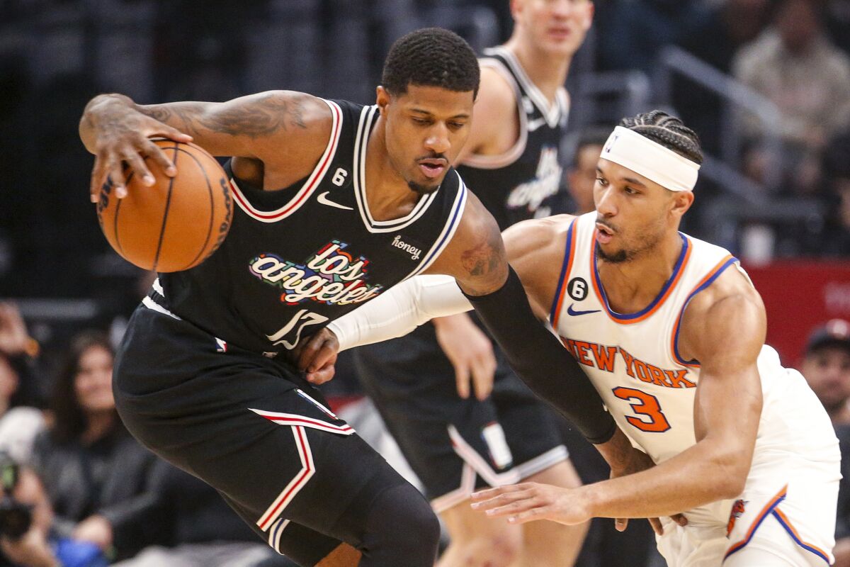 Los Angeles Clippers forward Paul George is defended by New York Knicks guard Josh Hart.