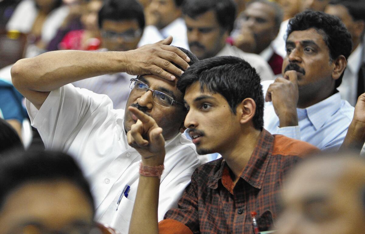 A college applicant watches a screen displaying seats allotted to students after he passed an entrance test in 2011.