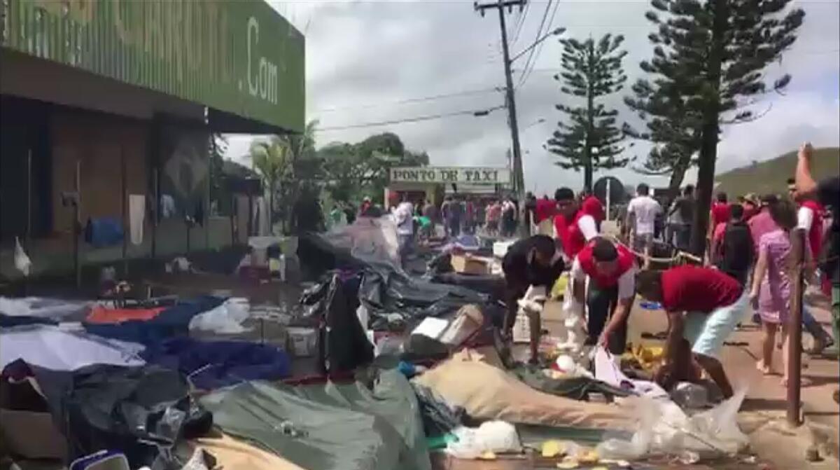 A still from an AFP video shows residents of the Brazilian border town of Pacaraima destroying belongings of Venezuelan immigrants during an attack on their makeshift camps Saturday.