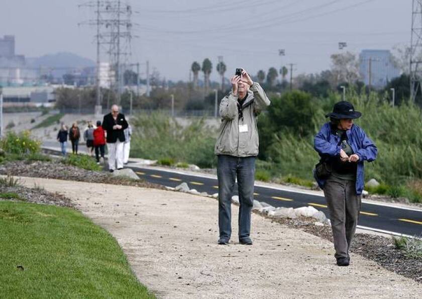 Bob Thompson takes a photo while Jeanne LeFever looks around during the grand opening of Phase 1 of the Glendale Narrows Riverwalk in Glendale on Wednesday.