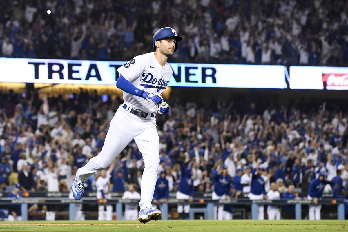 Dodgers' Trea Turner rounds the bases after hitting a solo home run.