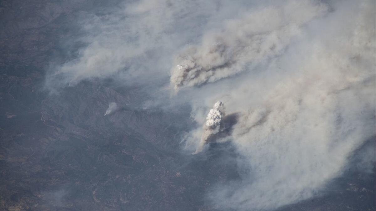 A photo taken from the International Space Station on Aug. 3 shows the Carr and Ferguson fires.