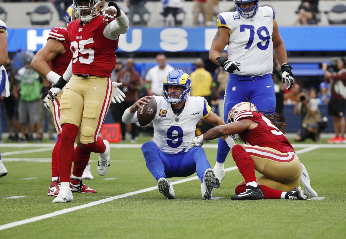Rams quarterback Matthew Stafford is sacked by 49ers linebacker Fred Warner.