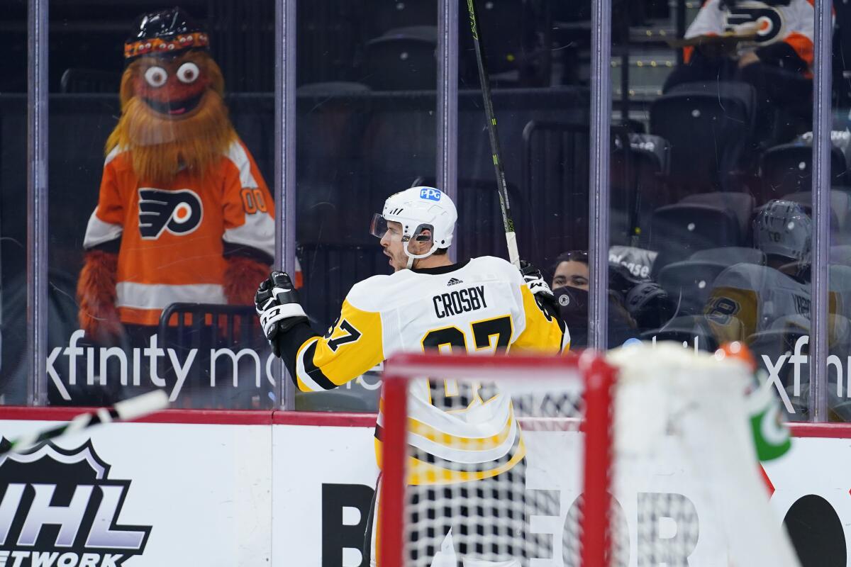 Pittsburgh Penguins' Sidney Crosby celebrates after scoring a goal during the second period of an NHL hockey game against the Philadelphia Flyers, Tuesday, May 4, 2021, in Philadelphia. (AP Photo/Matt Slocum)