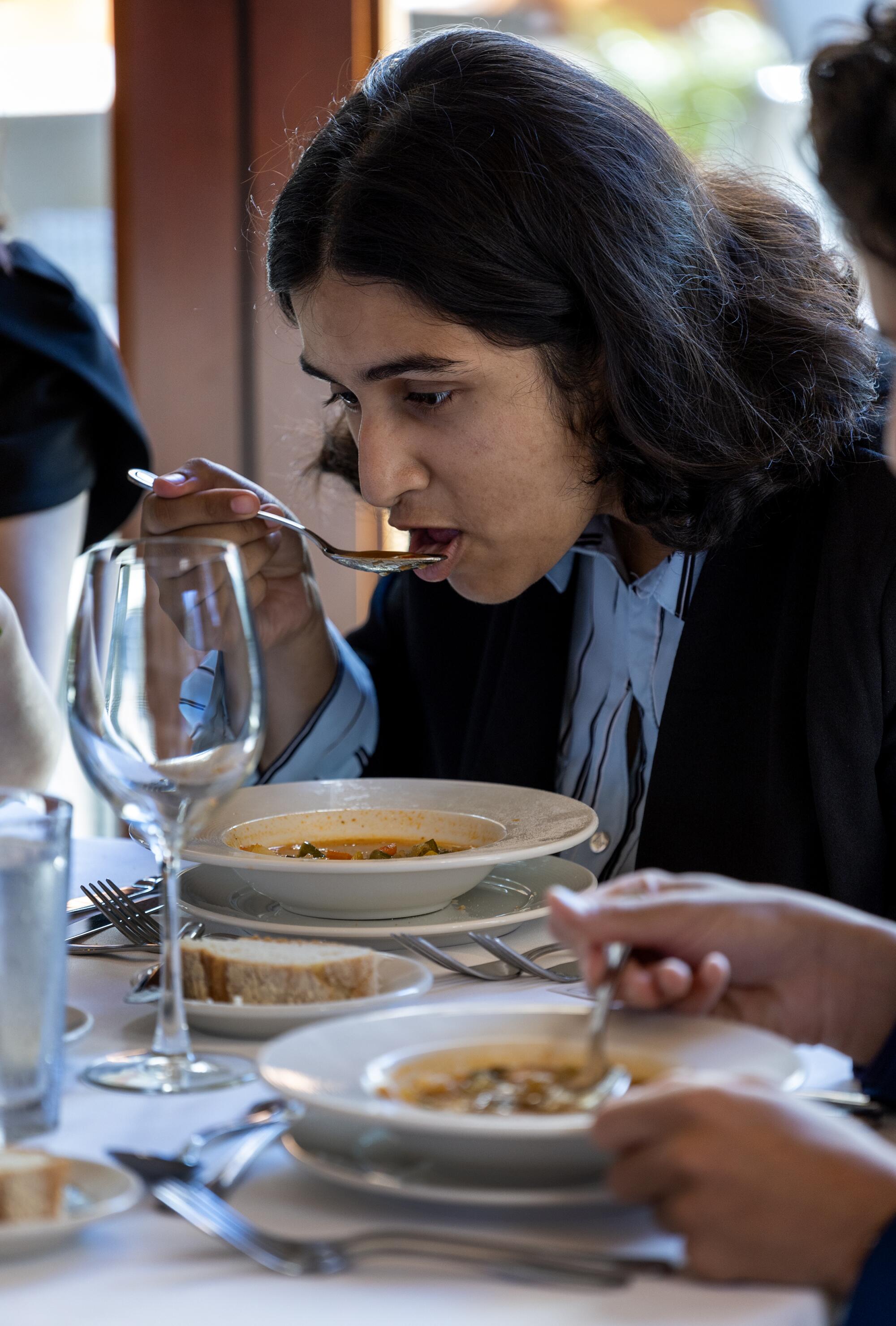 Student Simran Bhogle eats soup 