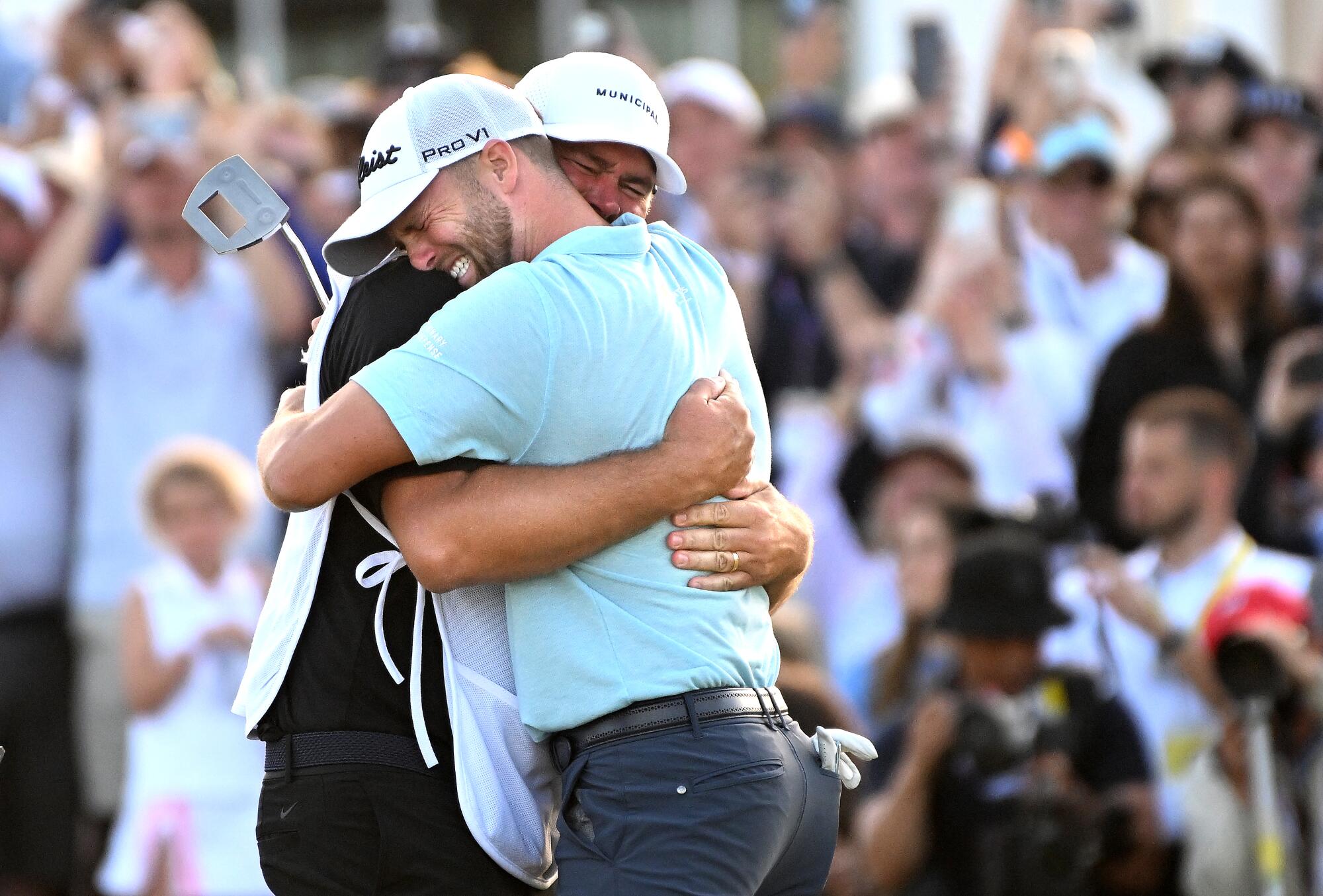 Wyndham Clark hugs his caddie after winning the U.S. Open on Sunday.