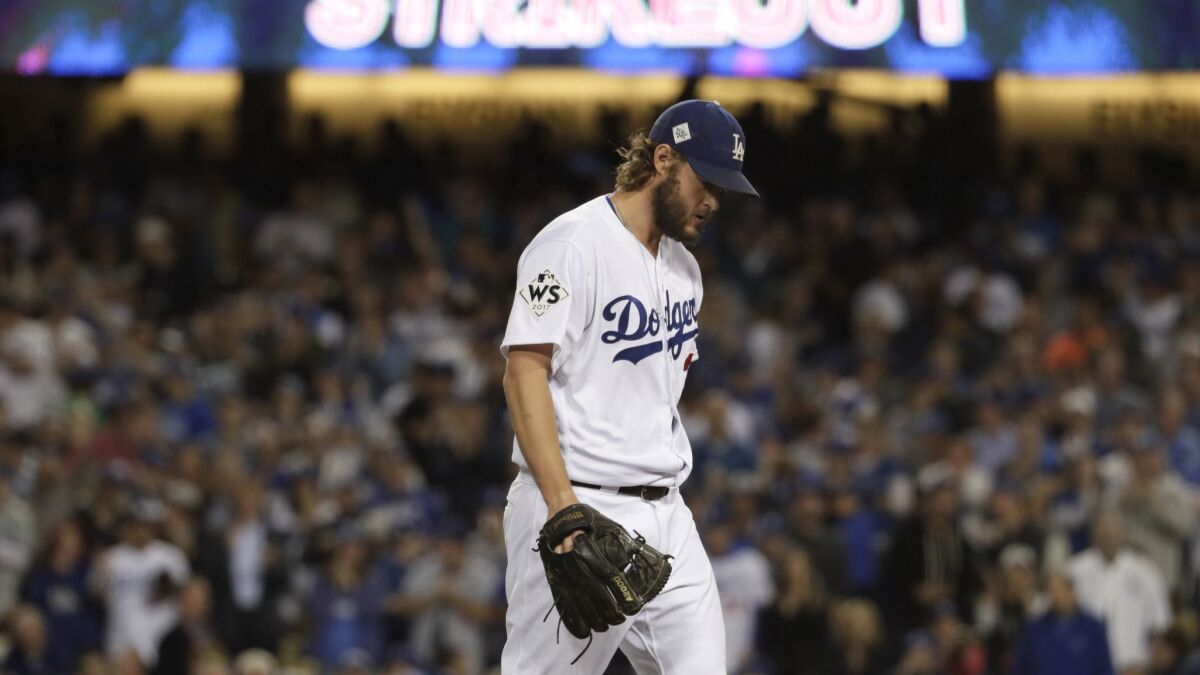 Clayton Kershaw walks back to the dugout after striking out Yuli Gurriel to end the third inning in Game 7 of the World Series.