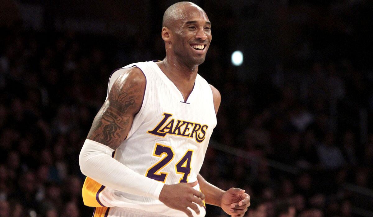 Lakers guard Kobe Bryant is all smiles after scoring against the Pacers off an assist from teammate Carlos Boozer in the first half Sunday.