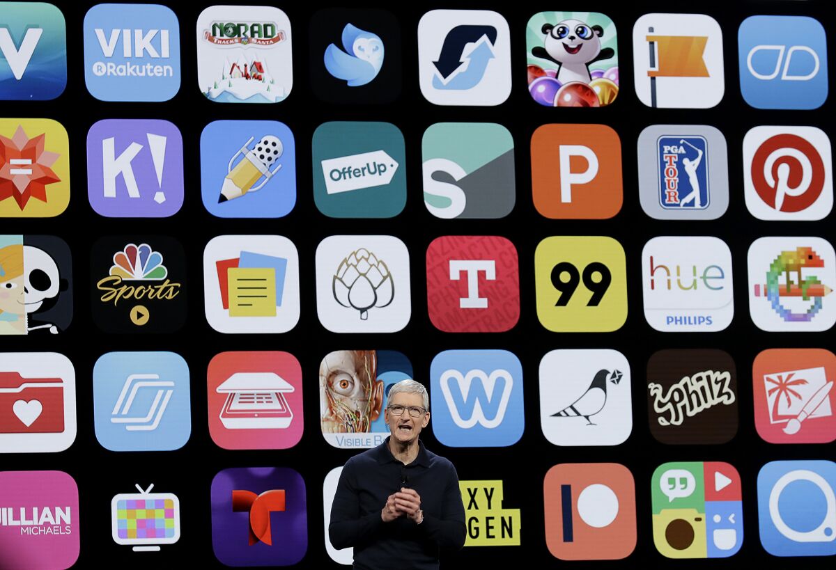 Apple CEO Tim Cook against a backdrop of smartphone app icons.