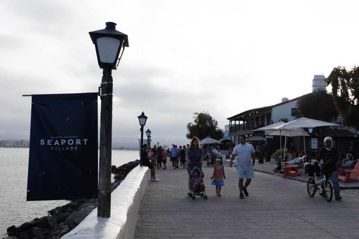 People stroll along Seaport Village on Friday, July 15, 2022. 