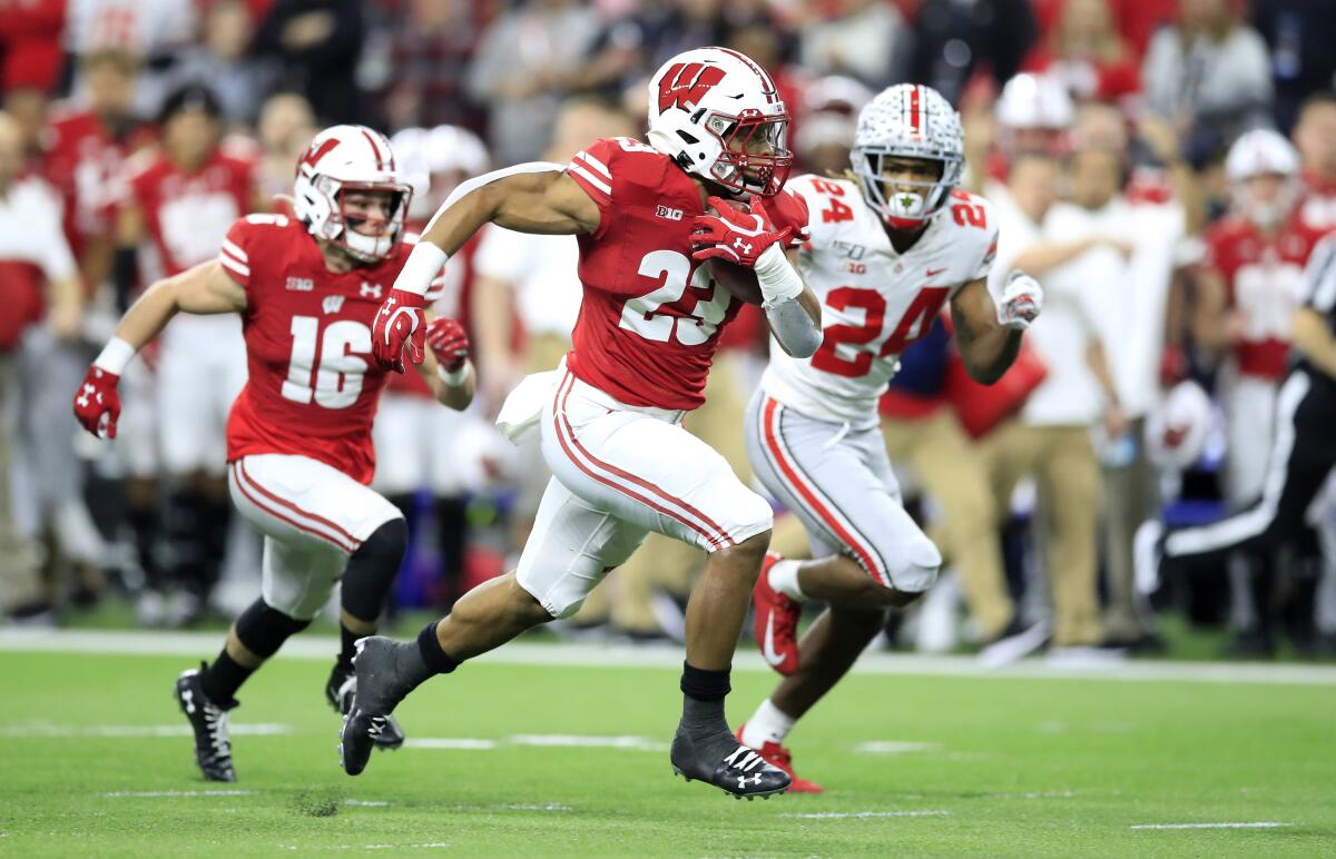 Wisconsin's Jonathan Taylor runs for a touchdown against Ohio State in December. 