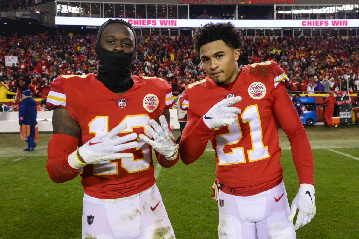 Chiefs safety Nazeeh Johnson (13) and cornerback Trent McDuffie (21) celebrate their playoff win over the Jaguars.