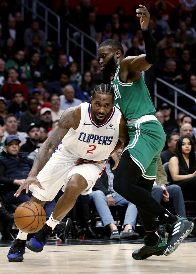 Clippers forward Kawhi Leonard drives to the basket against Celtics forward Jaylen Brown during the second quarter of a game Nov. 20 at Staples Center.