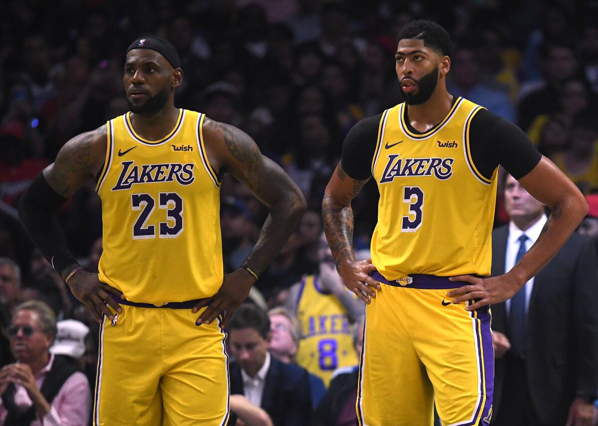 Lakers' LeBron James, left, and Anthony Davis react during a game at Staples Center.