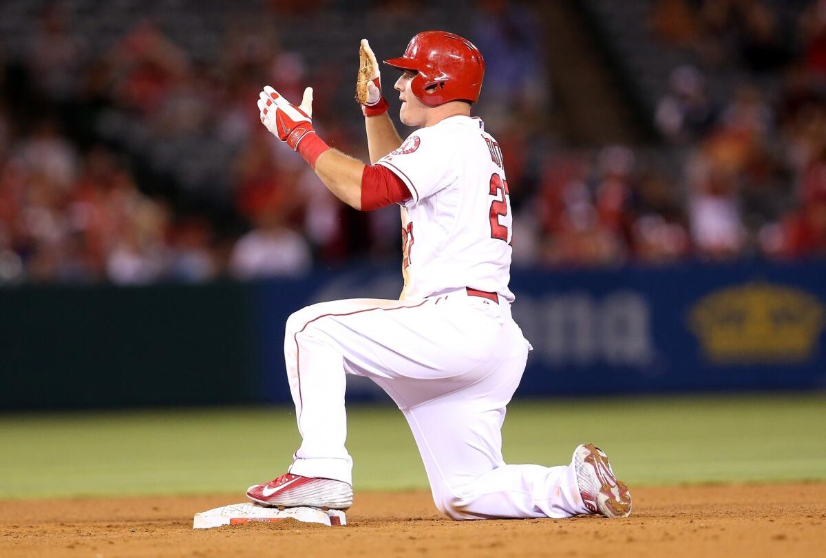 Mike Trout slides into second base for an RBI double in the fourth inning against the Marlins. The Angels beat the Marlins, 8-2.