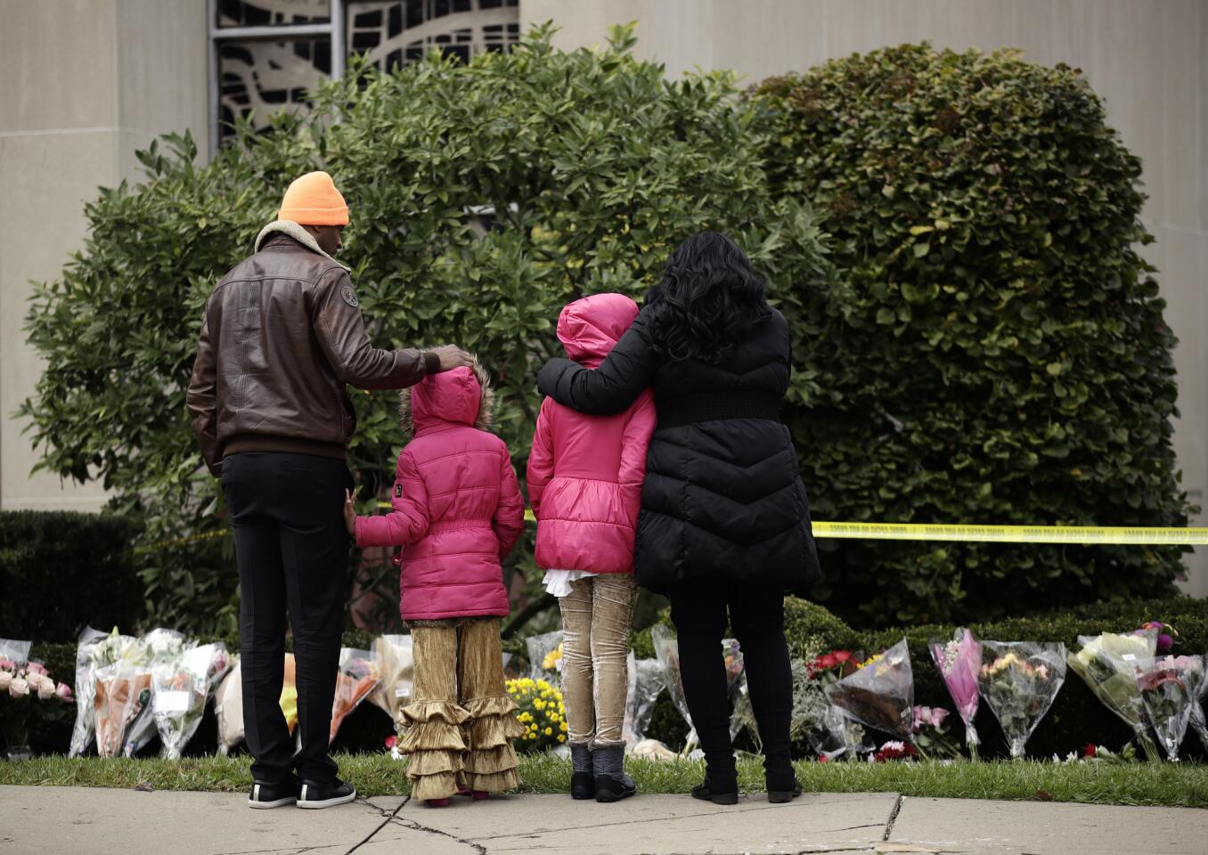 Mourners view a row of flowers at a memorial for the victims of the Tree of Life Synagogue shooting in Pittsburgh on Sunday.