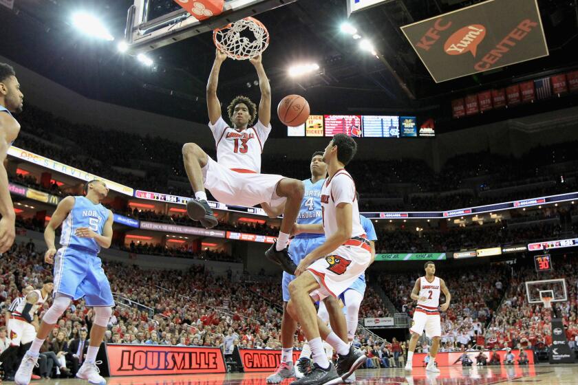 Louisville forward Ray Spalding (13) dunks the ball over North Carolina defenders during the Cardinals' 71-65 win.