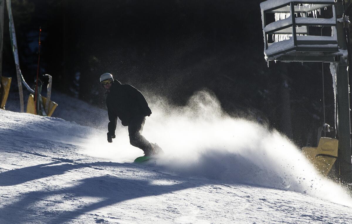 A snowboarder cuts across a slope at Mountain High ski resort in November. The resort is temporarily closed until new snow arrives.