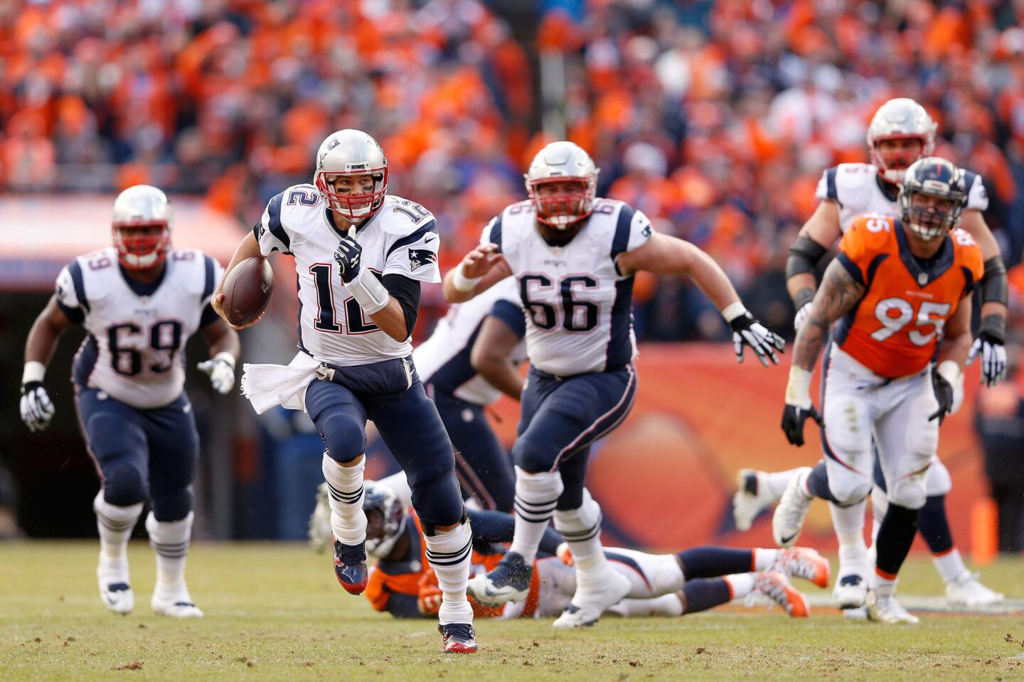 Patriots quarterback Tom Brady streaks for an 11-yard gain against the Broncos during the second quarter of the AFC Championship game on Jan. 24.