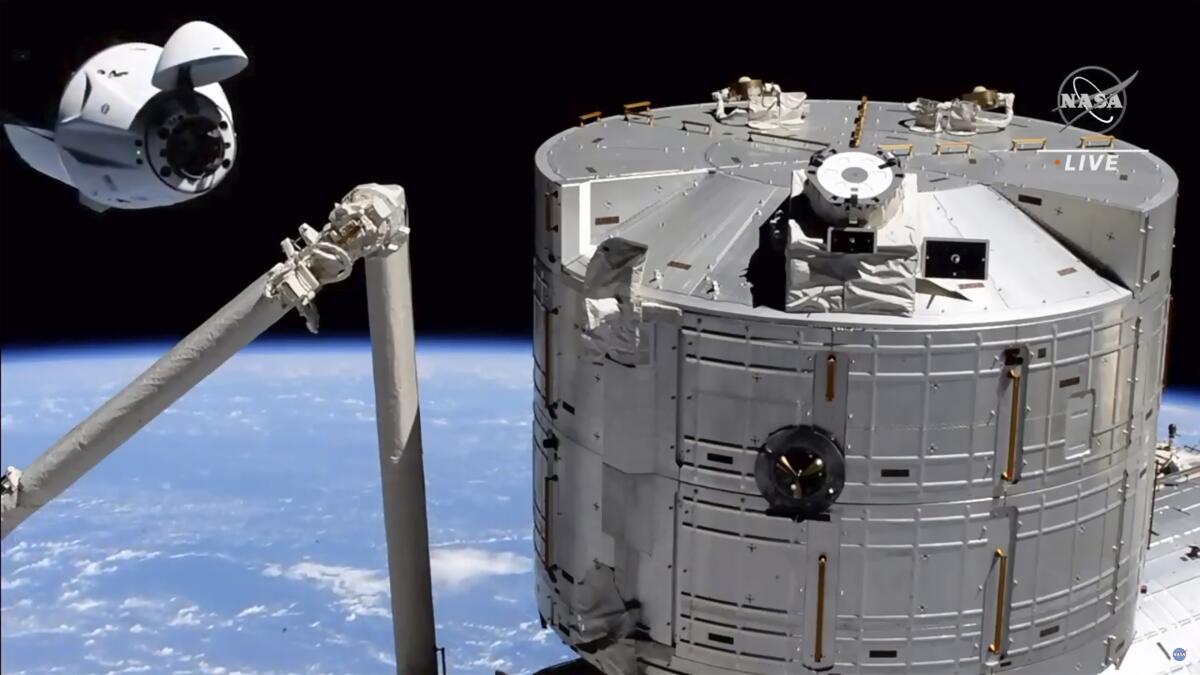 A SpaceX capsule approaches the International Space Station on Saturday.