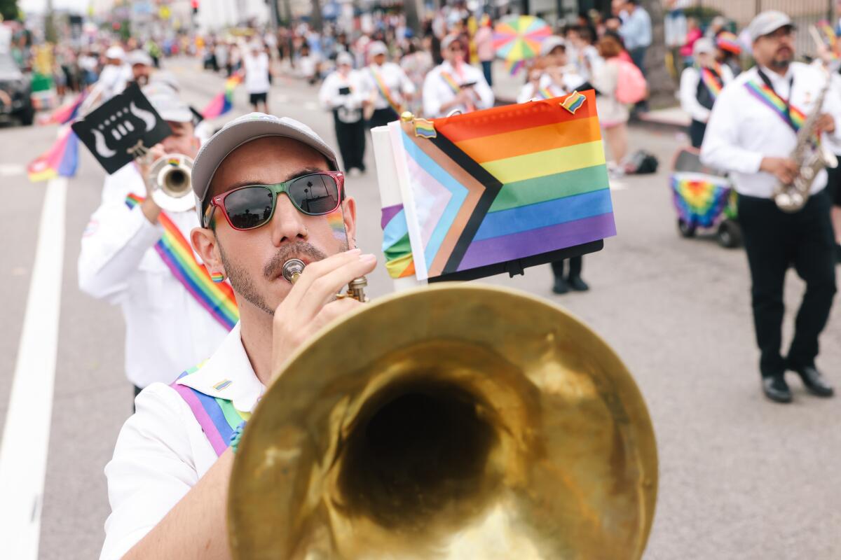 Los Angeles, CA - June 9: A member of the Los Angeles Gay Freedom Band plays his instrument during the Los Angeles Gay Pride Parade in Hollywood on Sunday, June 9, 2024 in Los Angeles, CA.  (Dania Maxwell / Los Angeles Times)