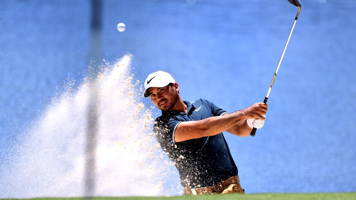 Jason Day hits out of a bunker during the third round of the Australian Open on Friday.
