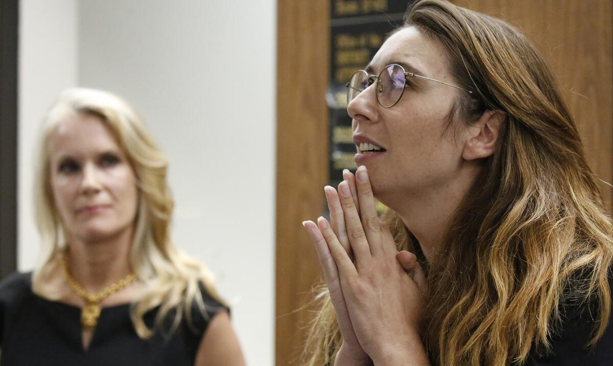 Jessica Gonzales, right, and Audry Nafziger hold a news conference after a bail review hearing for Dr. George Tyndall.