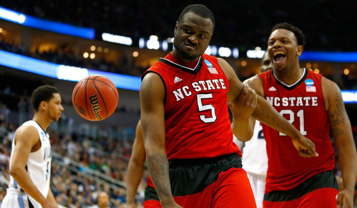 North Carolina State guard Desmond Lee (5) celebrates with forward Beejay Anya (21) after scoring and drawing a foul against Villanova in the Wolfpack's 71-68 upset of the No. 1-seeded Wildcats.