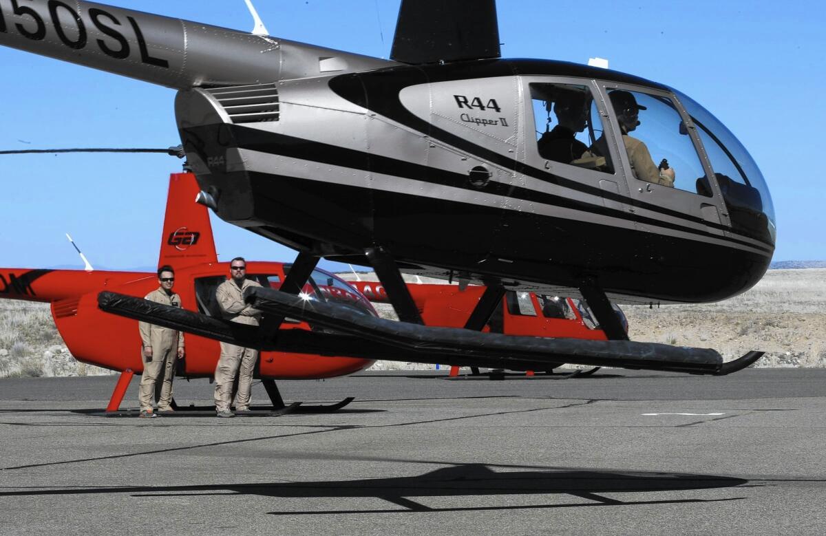 Guidance Aviation students Ryan Smith, left, and Richard Lyman watch another student lift off from Prescott Municipal Airport in Arizona. Both are U.S. military veterans whose training, room and board are fully funded through the Post-9/11 GI Bill.