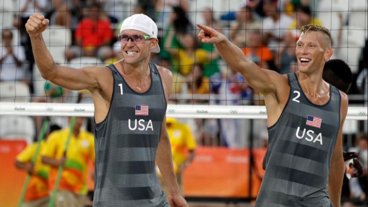 Casey Patterson, left, and Jake Gibb celebrate after winning a men's beach volleyball match over a team from Qatar at the 2016 Summer Olympics on Aug. 6.