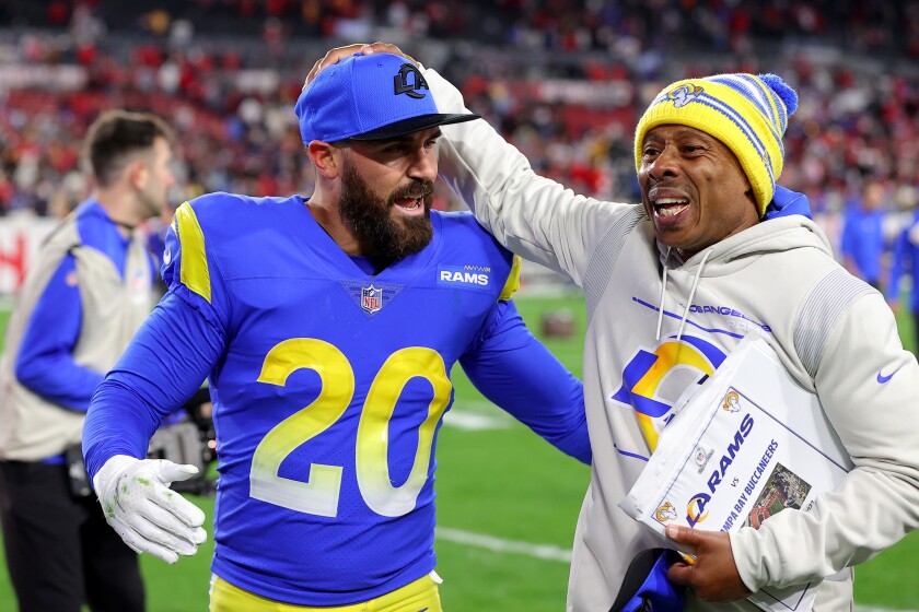 Los Angeles Rams safety Eric Weddle and coordinator Raheem Morris react after a 30-27 victory against the Buccaneers.