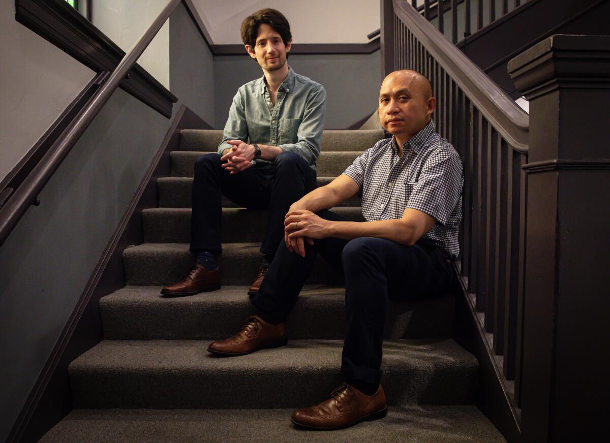 Noam Shapiro and Paulo K Tiról sit at a stairwell.