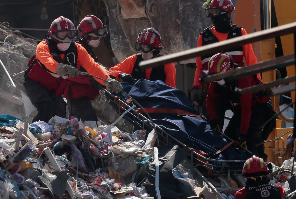 Rescuers remove a corpse from the rubble in Manta, Ecuador, on Wednesday.